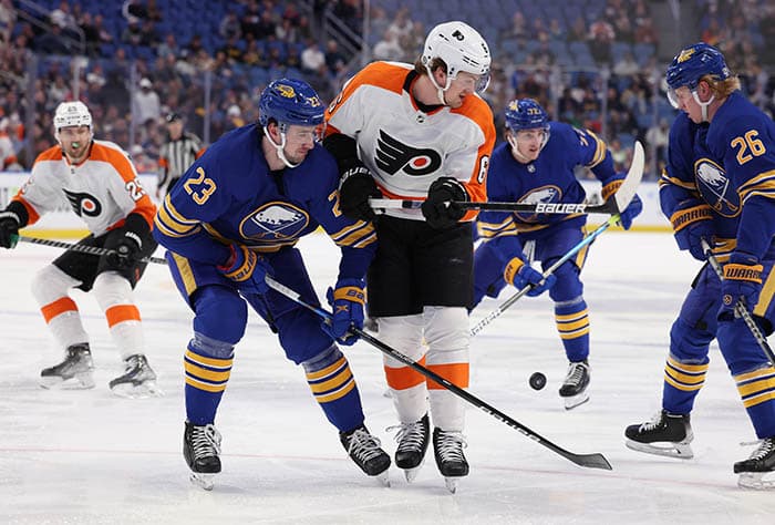 Buffalo Sabres defenseman Rasmus Dahlin (26) knocks the puck off the stick of Philadelphia Flyers defenseman Travis Sanheim (6) during the first period at KeyBank Center.