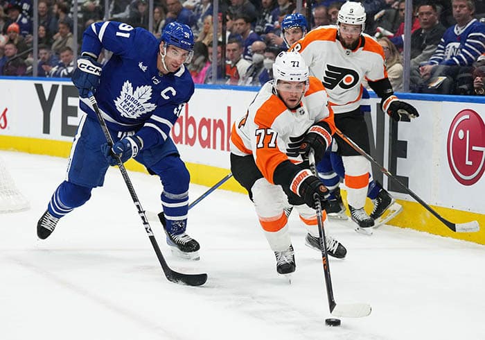 Philadelphia Flyers defenseman Tony DeAngelo (77) battles for the puck with Toronto Maple Leafs center John Tavares (91) during the first period at Scotiabank Arena