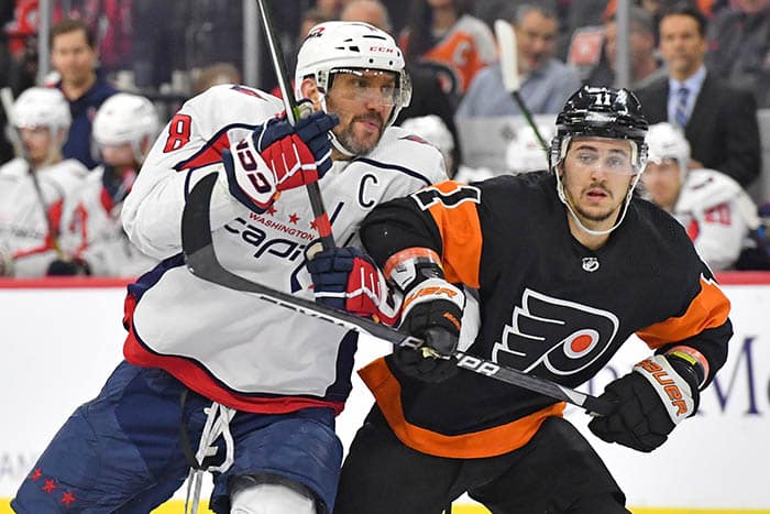 Washington Capitals left wing Alex Ovechkin (8) and Philadelphia Flyers right wing Travis Konecny (11) battle during the third period at Wells Fargo Center.