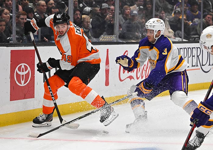 Philadelphia Flyers left wing Noah Cates (49) and Los Angeles Kings defenseman Matt Roy (3) battle for the puck in the first period of the game at Crypto.com Arena.
