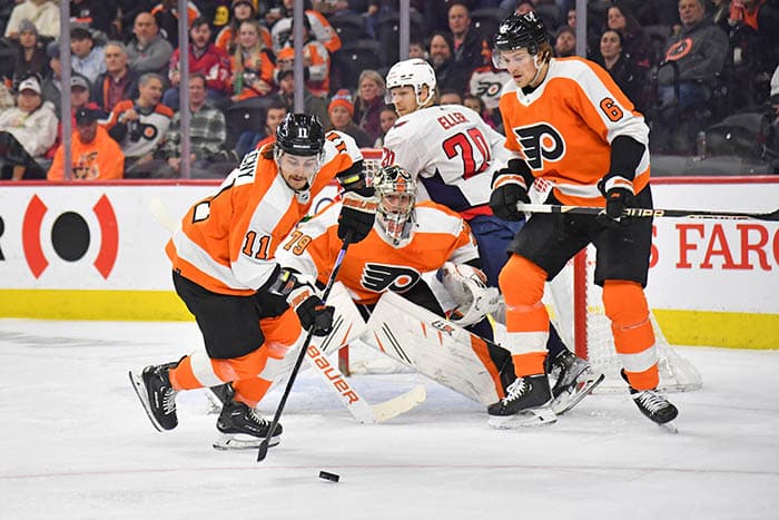 Philadelphia Flyers right wing Travis Konecny (11) clears the puck against the Washington Capitals during the first period at Wells Fargo Center.
