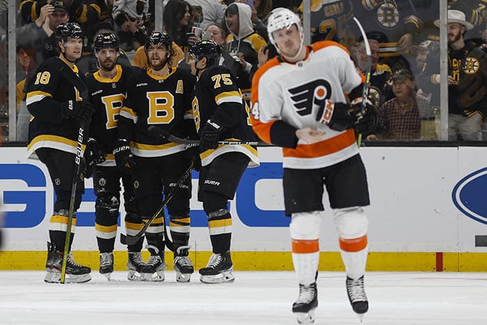 Boston Bruins center Pavel Zacha (18) is congratulated by teammates David Krejci, David Pastrnak and defenseman Connor Clifton (75) after he scored as Philadelphia Flyers defenseman Nick Seeler (24) skates away during the second period at TD Garden.