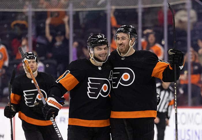Philadelphia Flyers center Kevin Hayes (13) celebrates with center Scott Laughton (21) after scoring a goal for a hat trick against the Anaheim Ducks during the third period at Wells Fargo Center. 