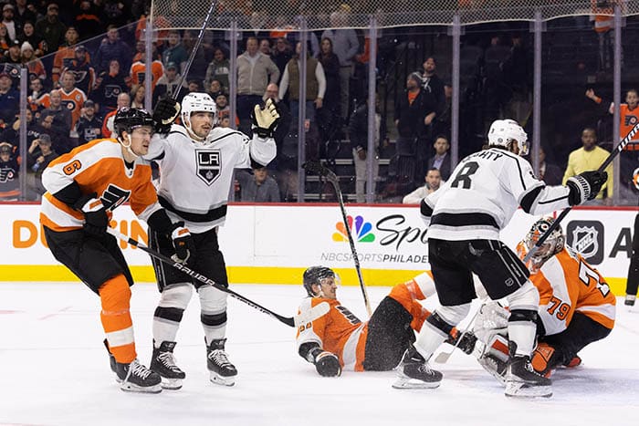 Los Angeles Kings left wing Kevin Fiala (22) reacts alongside defenseman Drew Doughty (8) in front of Philadelphia Flyers defenseman Travis Sanheim (6) and goaltender Carter Hart (79) after scoring the game winning goal during the overtime period at Wells Fargo Center.