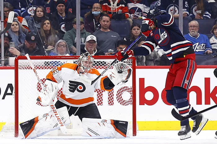 Philadelphia Flyers goaltender Carter Hart (79) gloves a tip in attempt by Winnipeg Jets center Kevin Stenlund (28) in the first period at Canada Life Centre. 