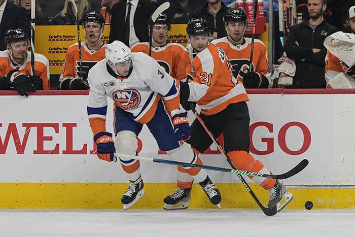 Philadelphia Flyers center Scott Laughton (21) and New York Islanders defenseman Adam Pelech (3) battle along the boards in the third period at Wells Fargo Center. The Philadelphia Flyers won 3-1.