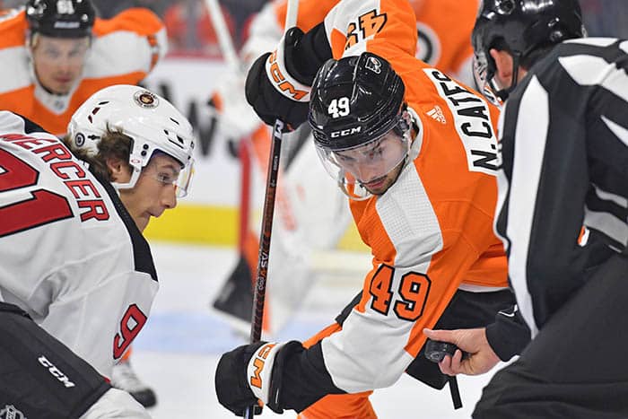 Philadelphia Flyers left wing Noah Cates (49) and New Jersey Devils center Dawson Mercer (91) face-off at Wells Fargo Center.