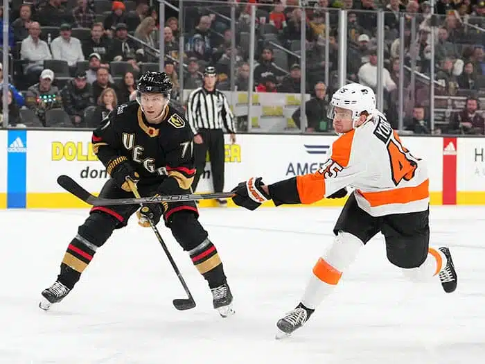 Philadelphia Flyers defenseman Cam York (45) shoots beside Vegas Golden Knights center William Karlsson (71) during the first period at T-Mobile Arena.