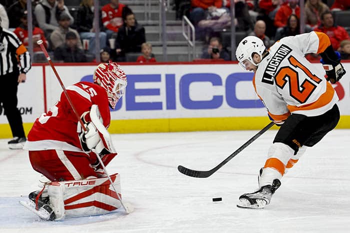 Philadelphia Flyers center Scott Laughton (21) skates in on Detroit Red Wings goaltender Ville Husso (35) to score a goal in the third period at Little Caesars Arena. 