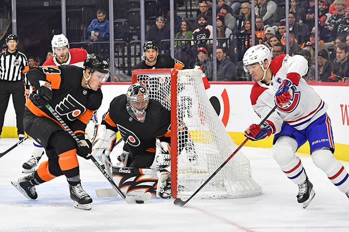 Philadelphia Flyers defenseman Nick Seeler (24) blocks shot attempt by Montreal Canadiens center Nick Suzuki (14) against goaltender Carter Hart (79) during the second period at Wells Fargo Center.