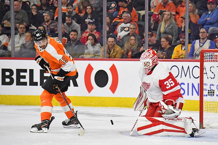Philadelphia Flyers left wing Noah Cates (49) deflects the puck past Detroit Red Wings goaltender Ville Husso (35) during the second period at Wells Fargo Center.