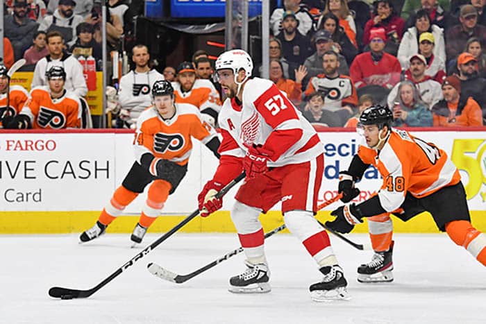 Detroit Red Wings left wing David Perron (57) controls the puck against Philadelphia Flyers center Morgan Frost (48) during the third period at Wells Fargo Center.