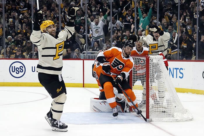 Pittsburgh Penguins left wing Jason Zucker (left) reacts after scoring a goal against the Philadelphia Flyers during the third period at PPG Paints Arena. Pittsburgh won 5-1.