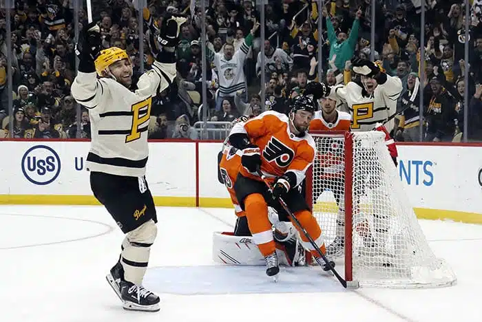 Pittsburgh Penguins left wing Jason Zucker (left) reacts after scoring a goal against the Philadelphia Flyers during the third period at PPG Paints Arena. Pittsburgh won 5-1. 
