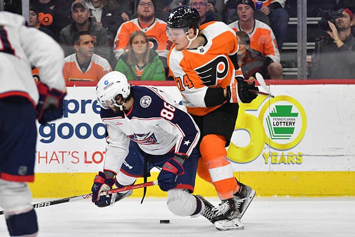 Columbus Blue Jackets right wing Kirill Marchenko (86) and Philadelphia Flyers right wing Owen Tippett (74) battle for the puck during the second period at Wells Fargo Center.