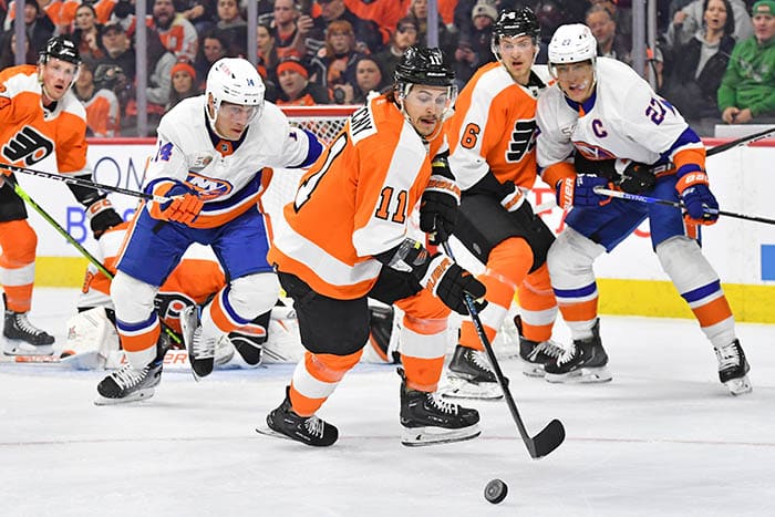 Philadelphia Flyers right wing Travis Konecny (11) picks up loose puck away from New York Islanders center Bo Horvat (14) during the first period at Wells Fargo Center.