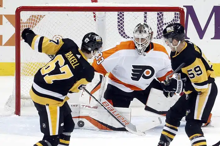 Pittsburgh Penguins right wing Rickard Rakell (67) scores a goal against Philadelphia Flyers goaltender Samuel Ersson (33) during the first period at PPG Paints Arena.