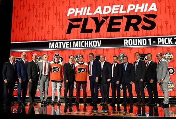 Philadelphia Flyers draft pick Matvei Michkov stands with Flyers staff after being selected with the seventh pick in round one of the 2023 NHL Draft at Bridgestone Arena.