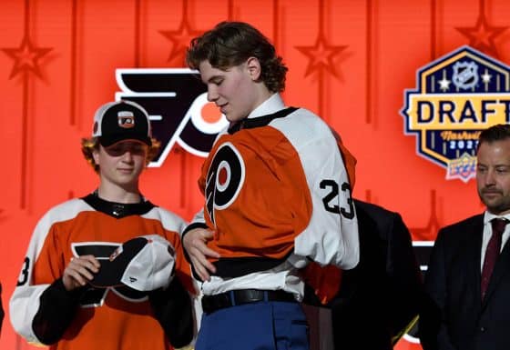 Philadelphia Flyers draft pick Oliver Bonk puts on his sweater after being selected with the twenty second pick in round one of the 2023 NHL Draft at Bridgestone Arena.