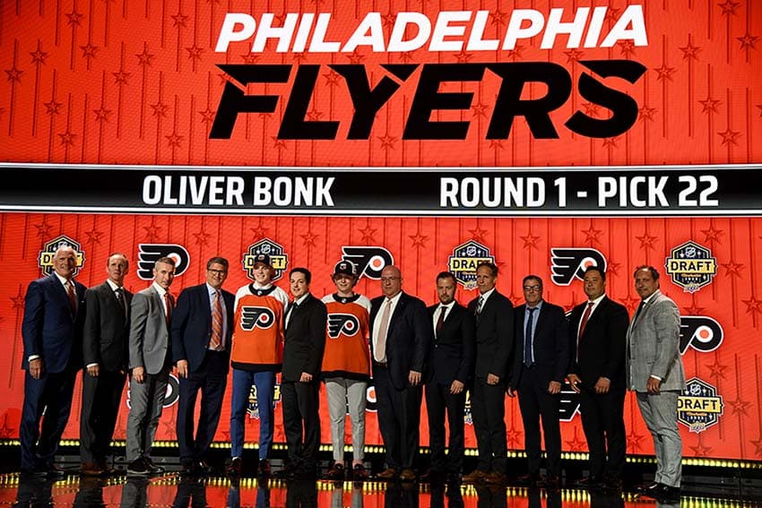 Philadelphia Flyers draft pick Oliver Bonk stands with Flyers staff after being selected with the twenty second pick in round one of the 2023 NHL Draft at Bridgestone Arena.