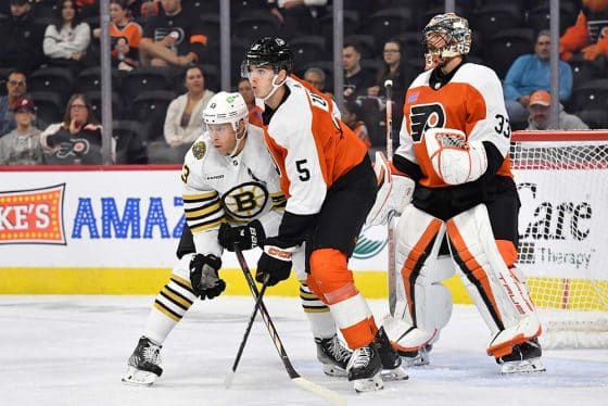 Boston Bruins center Charlie Coyle (13) and Philadelphia Flyers defenseman Egor Zamula (5) battle for position at Wells Fargo Center.