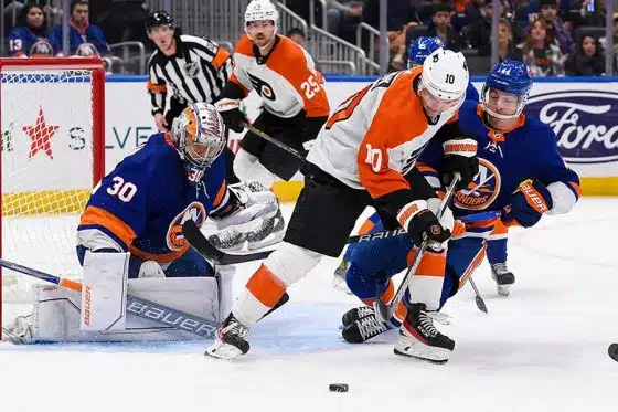Philadelphia Flyers right wing Bobby Brink (10) and New York Islanders center Jean-Gabriel Pageau (44)] battle for the puck in front of New York Islanders goaltender Ilya Sorokin (30) during the first period at UBS Arena.