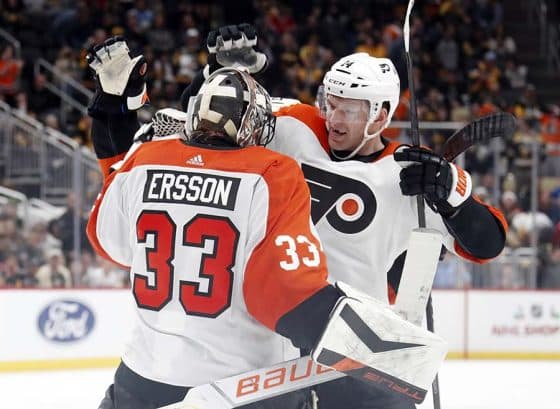 Philadelphia Flyers goaltender Samuel Ersson (33) and center Sean Couturier (14) celebrate after defeating the Pittsburgh Penguins in a shootout at PPG Paints Arena. The Flyers won 4-3 in a shootout.