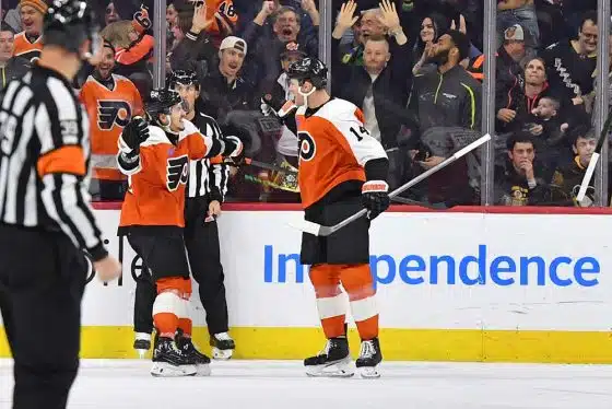 Philadelphia Flyers center Sean Couturier (14) celebrates his game-winning goal with right wing Travis Konecny (11) in overtime against the Pittsburgh Penguins at Wells Fargo Center.