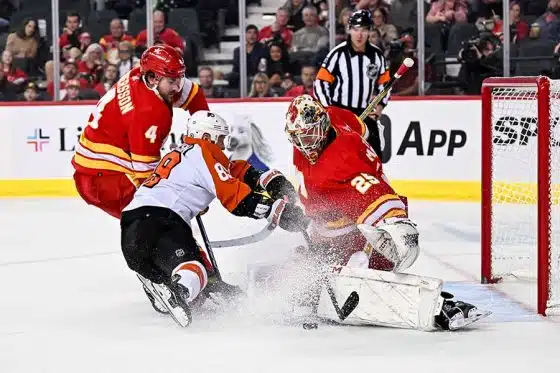 Calgary Flames goaltender Jacob Markstrom (25) stops Philadelphia Flyers right wing Cam Atkinson (89) in tight during the second period at Scotiabank Saddledome.
