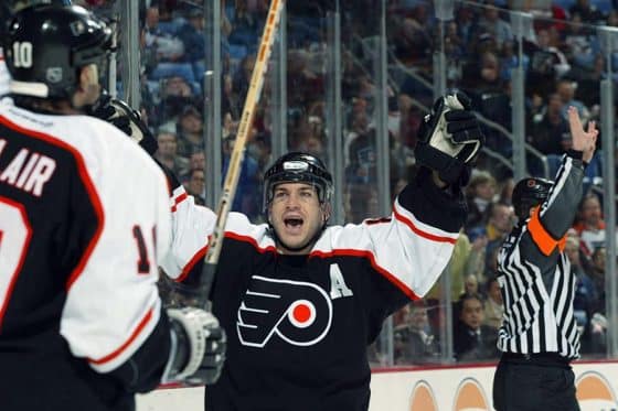 Right wing Mark Recchi #8 of the Philadelphia Flyers celebrates a goal with teammate left wing John LeClair #10 during the game against the Buffalo Sabres at HSBC Arena on March 18, 2003 in Buffalo, New York. The Sabres won 5-2.