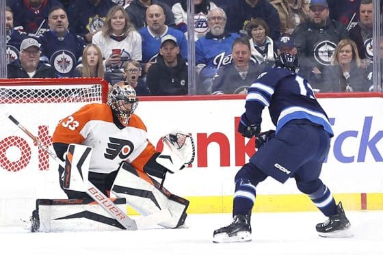 Philadelphia Flyers goaltender Samuel Ersson (33) makes a glove save off a Winnipeg Jets center Gabriel Vilardi (13) shot in the first period at Canada Life Centre.