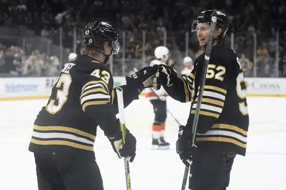 Boston Bruins left wing Danton Heinen (43) is congratulated by defenseman Andrew Peeke (52) after scoring a goal during the third period against the Philadelphia Flyers at TD Garden.