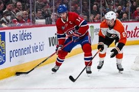 Montreal Canadiens center Nick Suzuki (14) plays the puck against Philadelphia Flyers defenseman Cam York (8) during the second period at Bell Centre.