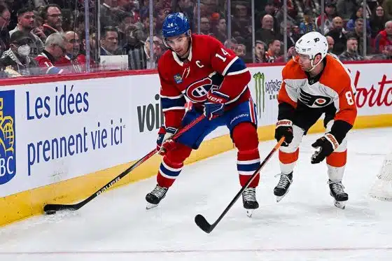 Montreal Canadiens center Nick Suzuki (14) plays the puck against Philadelphia Flyers defenseman Cam York (8) during the second period at Bell Centre.
