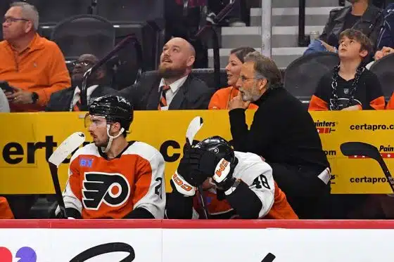 Philadelphia Flyers left wing Noah Cates (27) and center Morgan Frost (48) on the bench with head coach John Tortorella in the final seconds of loss against the Washington Capitals during the third period at Wells Fargo Center.