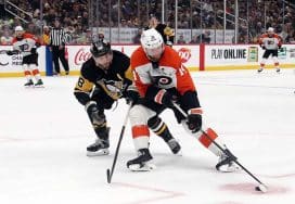 Dec 23, 2024; Pittsburgh, Pennsylvania, USA; Philadelphia Flyers center Sean Couturier (14) skates in on goal ahead of Pittsburgh Penguins defenseman Kris Letang (58) during the second period at PPG Paints Arena.
