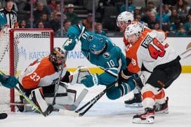 Dec 31, 2024; San Jose, California, USA; San Jose Sharks center Klim Kostin (10) is checked by Philadelphia Flyers center Morgan Frost (48) and defenseman Nick Seeler (24) as goaltender Samuel Ersson (33) protects the net during the second period at SAP Center at San Jose.