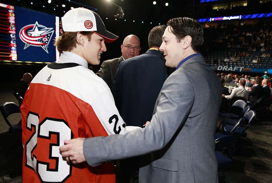 NASHVILLE, TENNESSEE - JUNE 29: Denver Barkey talks with general manager Daniel Briere of the Philadelphia Flyers after being selected 95th overall during the 2023 Upper Deck NHL Draft - Rounds 2-7 at Bridgestone Arena on June 29, 2023 in Nashville, Tennessee.
