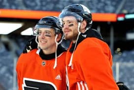 EAST RUTHERFORD, NEW JERSEY - FEBRUARY 16: (L-R) Morgan Frost #48 and Joel Farabee #86 of the Philadelphia Flyers pose for a photo before practice at MetLife Stadium on February 16, 2024 in East Rutherford, New Jersey.