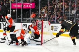Jan 2, 2025; Las Vegas, Nevada, USA; Vegas Golden Knights defenseman Nicolas Hague (14) banks a shot off the stick of Philadelphia Flyers defenseman Nick Seeler (24) to score a goal against goaltender Aleksei Kolosov (35) during the second period at T-Mobile Arena.