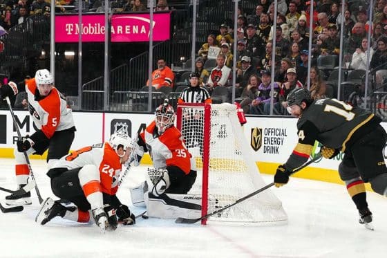 Jan 2, 2025; Las Vegas, Nevada, USA; Vegas Golden Knights defenseman Nicolas Hague (14) banks a shot off the stick of Philadelphia Flyers defenseman Nick Seeler (24) to score a goal against goaltender Aleksei Kolosov (35) during the second period at T-Mobile Arena.