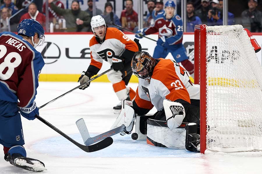DENVER, COLORADO - FEBRUARY 02: Samuel Ersson #33 of the Philadelphia Flyers makes a save against Martin Necas #88 of the Colorado Avalanche in the second period at Ball Arena on February 02, 2025 in Denver, Colorado.