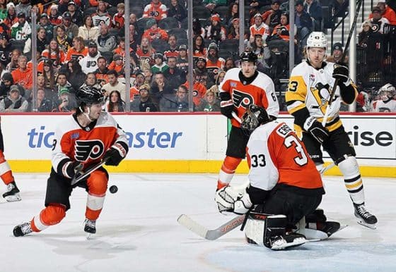 PHILADELPHIA, PENNSYLVANIA - FEBRUARY 08: Jamie Drysdale #9, Samuel Ersson #33 and Travis Sanheim #6 of the Philadelphia Flyers react to a shot on goal against Danton Heinen #43 of the Pittsburgh Penguins at the Wells Fargo Center on February 8, 2025 in Philadelphia, Pennsylvania.