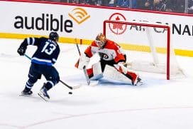WINNIPEG, CANADA - MARCH 1: Gabriel Vilardi #13 of the Winnipeg Jets closing in on Ivan Fedotov #82 of the Philadelphia Flyers in a shootout against the at Canada Life Centre on March 1, 2025 in Winnipeg, Canada.