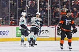 PHILADELPHIA, PENNSYLVANIA - MARCH 8: Tye Kartye #12 of the Seattle Kraken celebrates with Michael Eyssimont #21 against Jamie Drysdale #9 of the Philadelphia Flyers in the second period at the Wells Fargo Center on March 8, 2025 in Philadelphia, Pennsylvania.