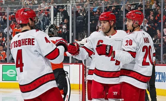 PHILADELPHIA, PENNSYLVANIA - MARCH 15: Taylor Hall #71 of the Carolina Hurricanes celebrates his second period power-play goal against the Philadelphia Flyers with Shayne Gostisbehere #4 and Sebastian Aho #20 at the Wells Fargo Center on March 15, 2025 in Philadelphia, Pennsylvania.