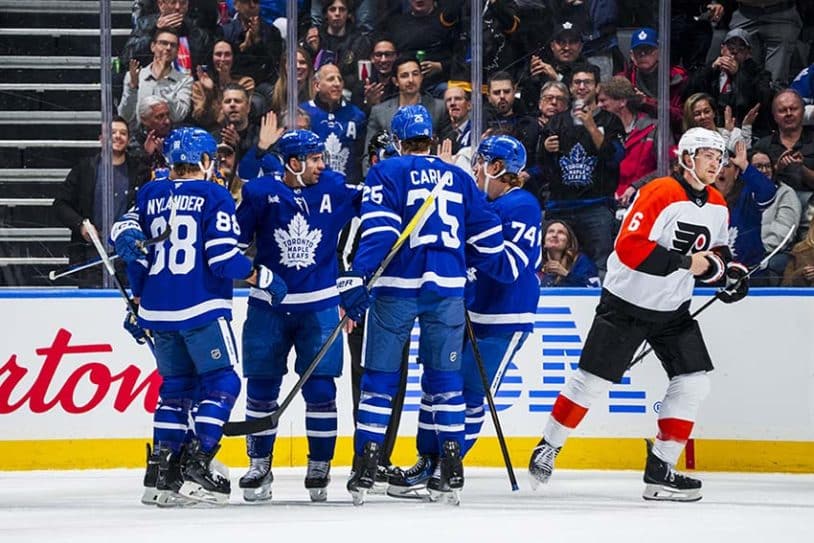TORONTO, ON - MARCH 25: John Tavares #91 of the Toronto Maple Leafs celebrate3s scoring a goal against the Philadelphia Flyers with his teammates during the first period at the Scotiabank Arena on March 25, 2025 in Toronto, Ontario, Canada.