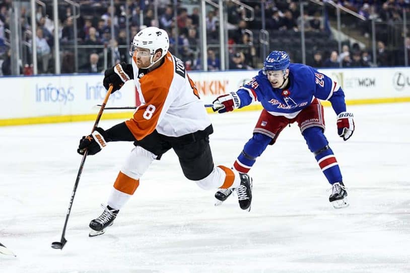 NEW YORK, NEW YORK - APRIL 11: Cam York #8 of the Philadelphia Flyers shoots and scores a goal ahead of Kaapo Kakko #24 of the New York Rangers during the first period at Madison Square Garden on April 11, 2024 in New York City.