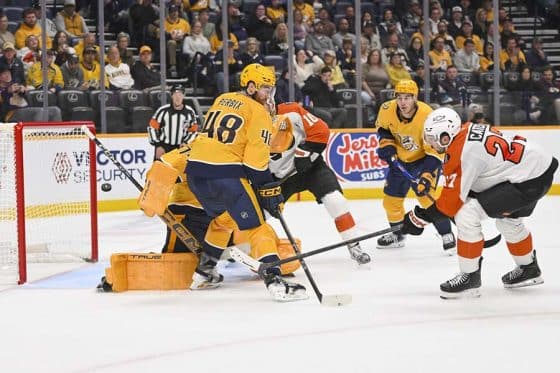Nov 6, 2025; Nashville, Tennessee, USA; Philadelphia Flyers left wing Noah Cates (27) scores past Nashville Predators goaltender Juuse Saros (74) during the second period at Bridgestone Arena.