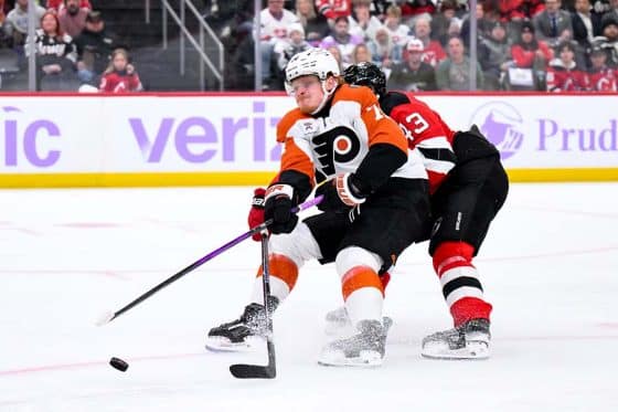 Nov 29, 2025; Newark, New Jersey, USA; Philadelphia Flyers right wing Owen Tippett (74) takes a shot as New Jersey Devils defenseman Luke Hughes (43) defends during the third period at Prudential Center.